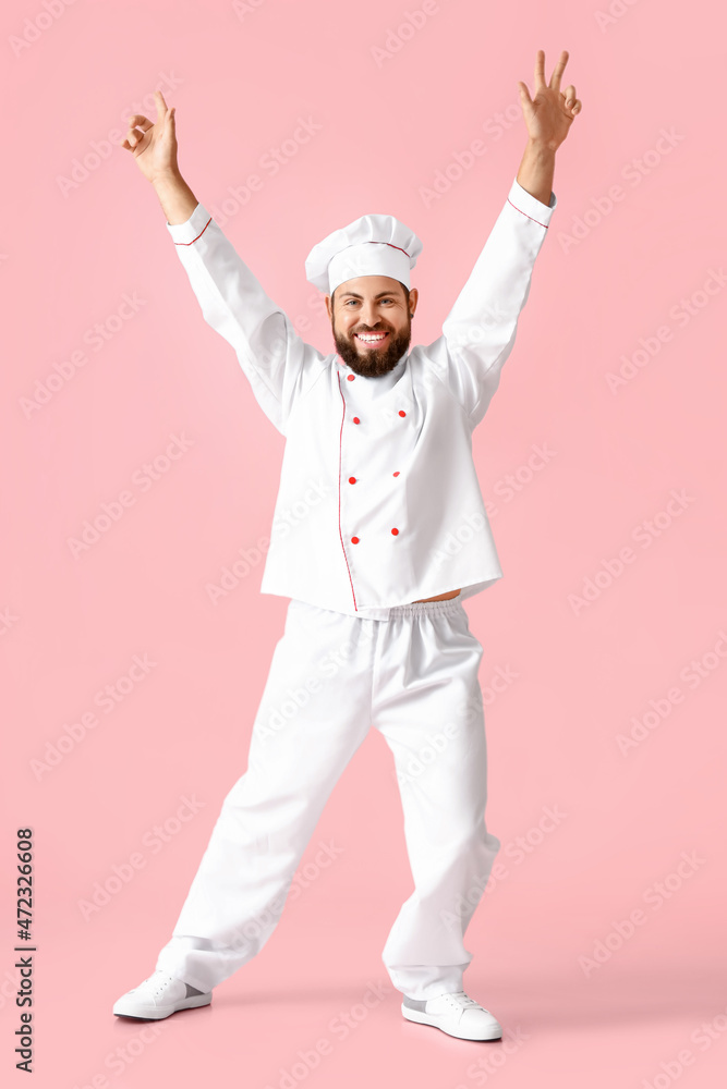 Dancing male chef on pink background