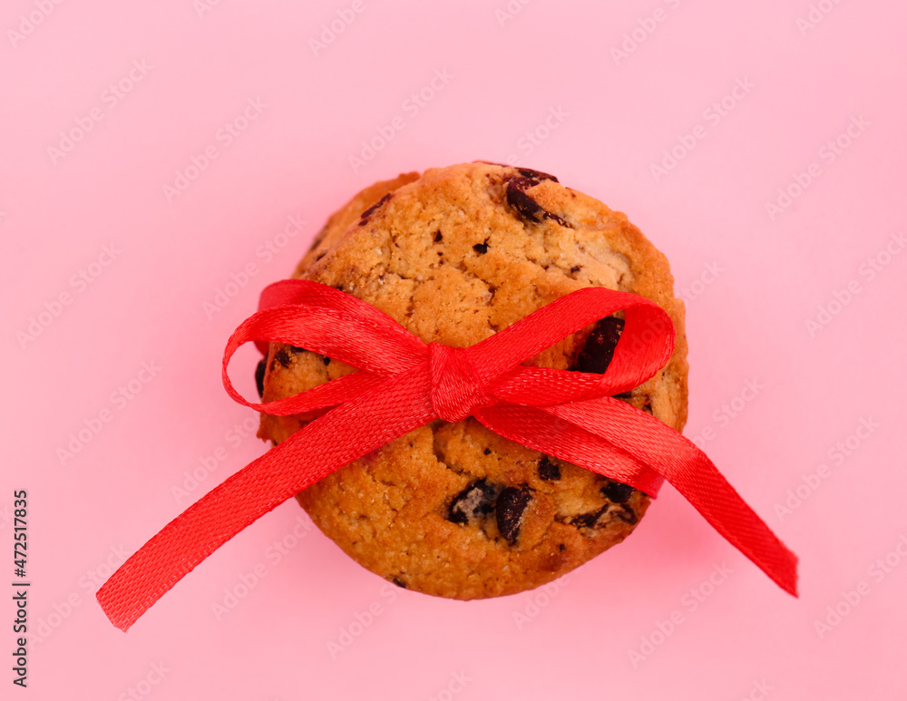 Tasty chocolate chips cookie on color background