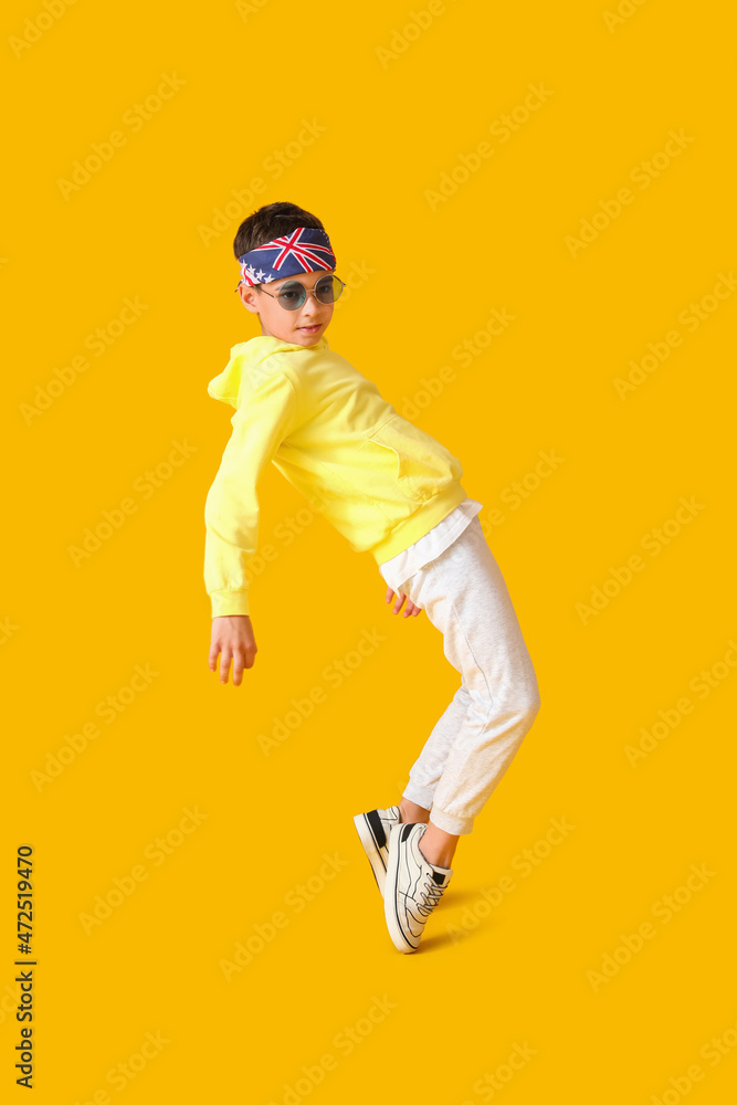 Dancing little boy on color background