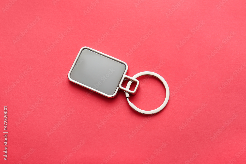 Stylish square keychain on red background