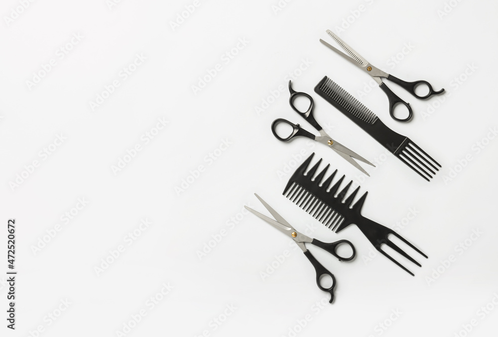 Scissors and combs on white background