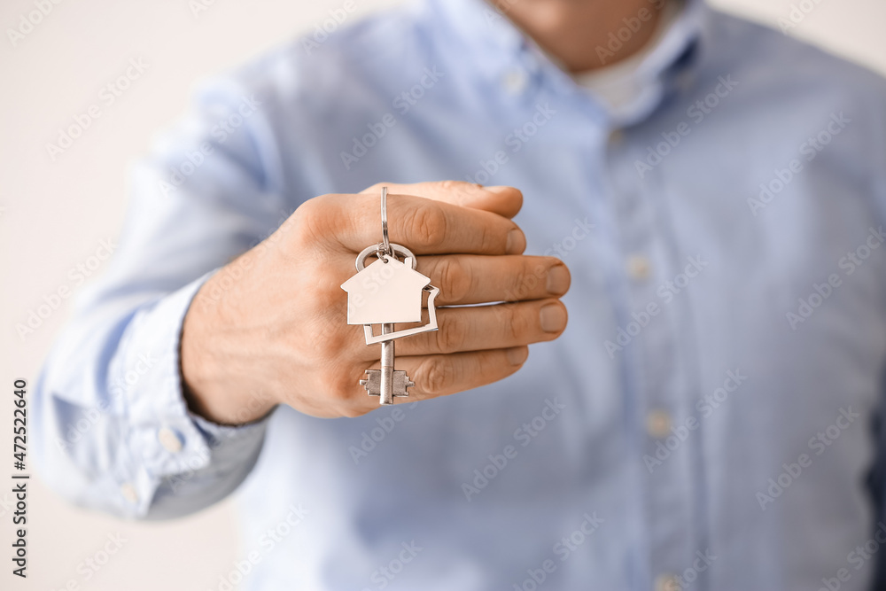 Man holding key from house, closeup