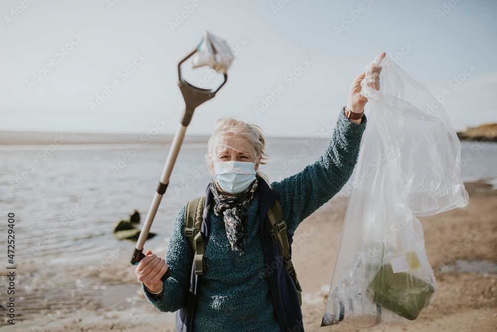 海滩清理志愿者背垃圾袋环保运动