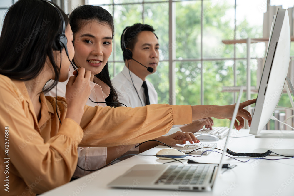 Business people wearing headset working actively in office . Call center, telemarketing, customer su