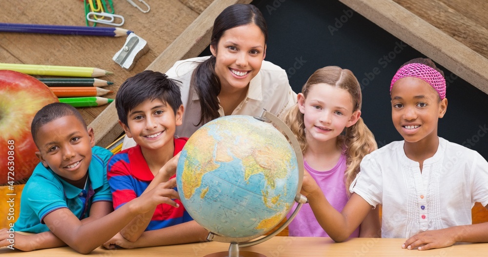 Portrait of smiling teacher and students learning about planet earth on globe