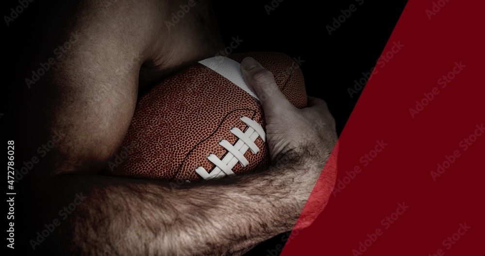 Midsection of shirtless muscular male american football athlete holding ball with copy space