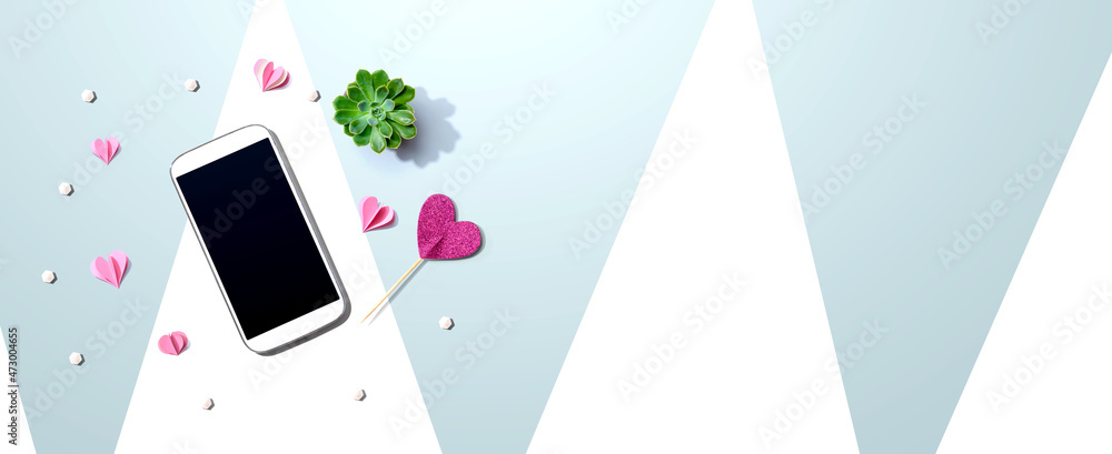 Smartphone with hearts and a succulent - flat lay