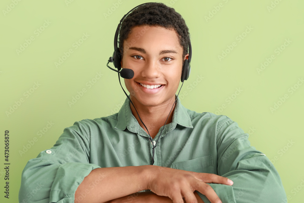 African-American technical support agent on color background