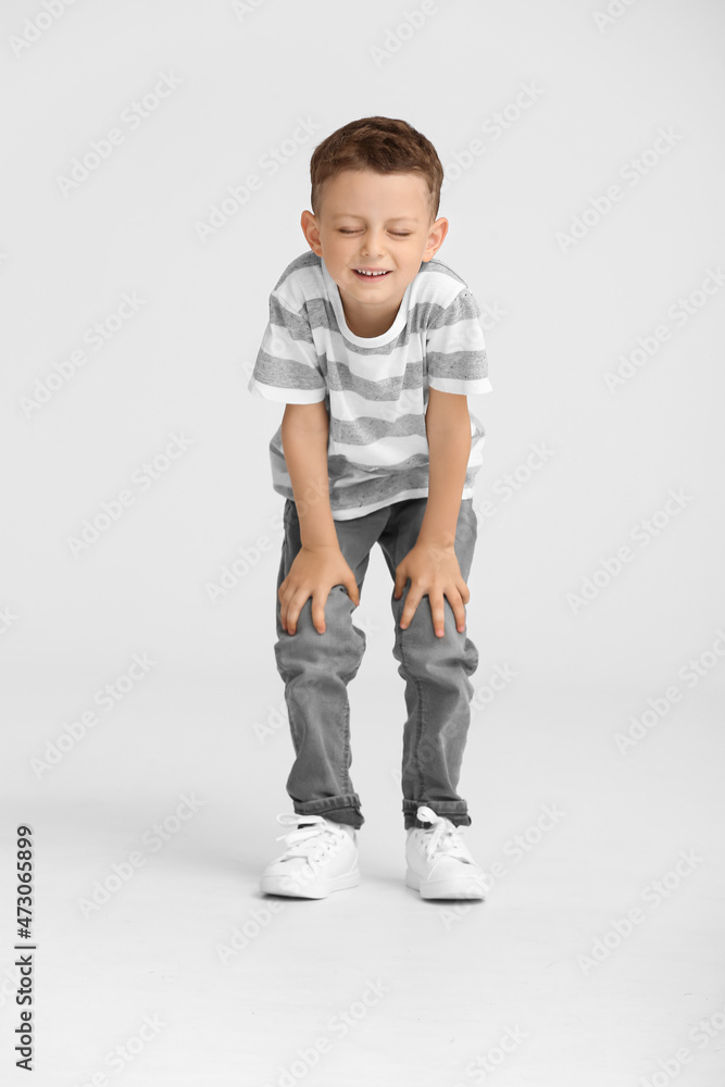 Portrait of happy little boy on light background