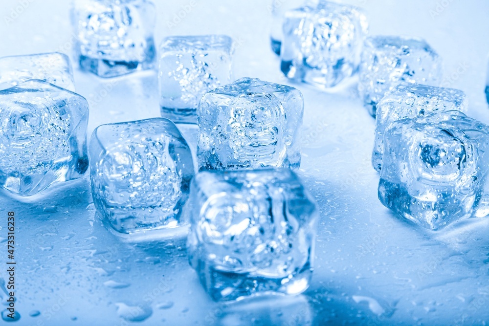 Top view. Ice cubes with water drops scattered on a background.