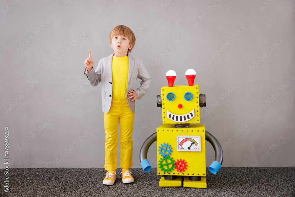 Happy child playing with robot