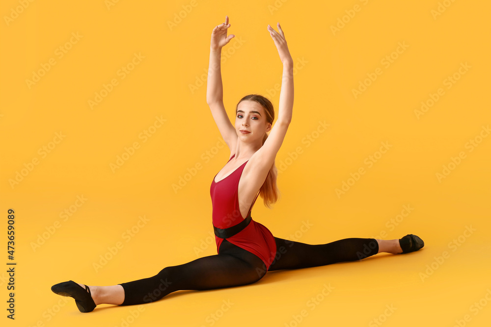 Beautiful young woman doing gymnastics on color background