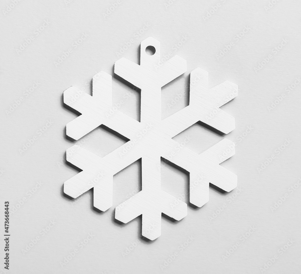 Beautiful snowflake on light background