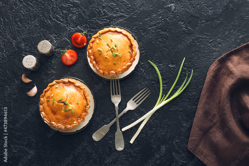 Tasty beef pot pies on dark background