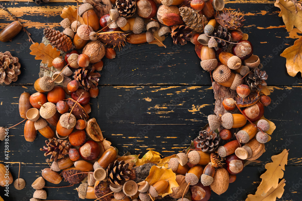 Beautiful acorn wreath on black wooden background