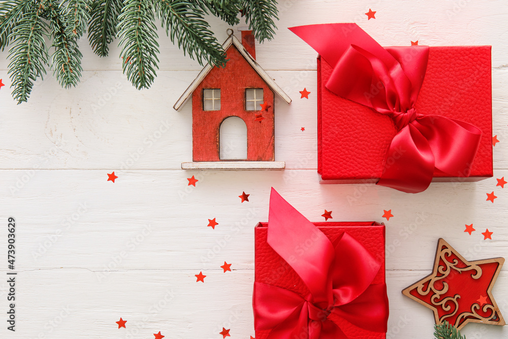 Beautiful composition with Christmas gift boxes, fir branches and decor on white wooden background