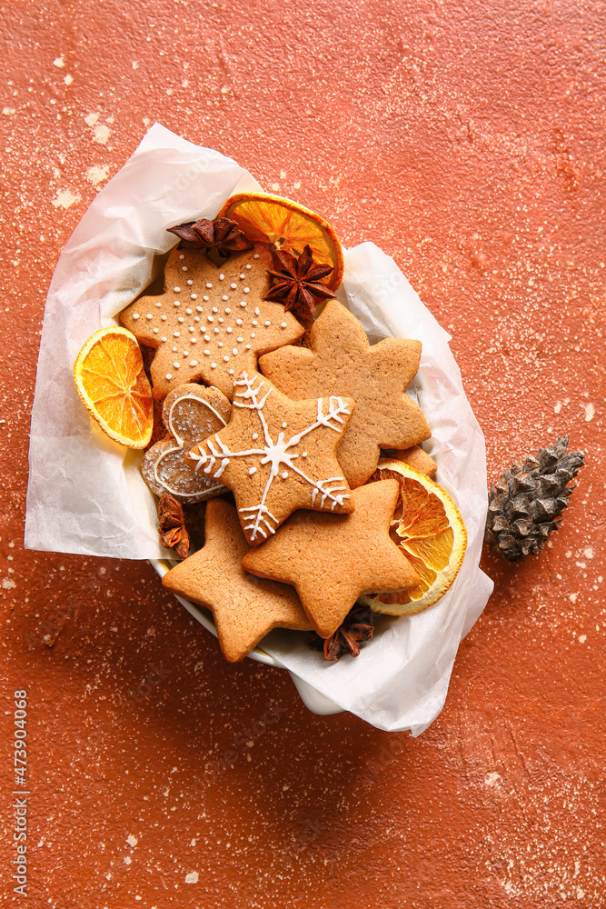 Basket with sweet Christmas gingerbread cookies on red background