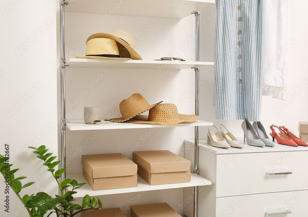 Shelves with stylish hats, shoes and clothes in boutique