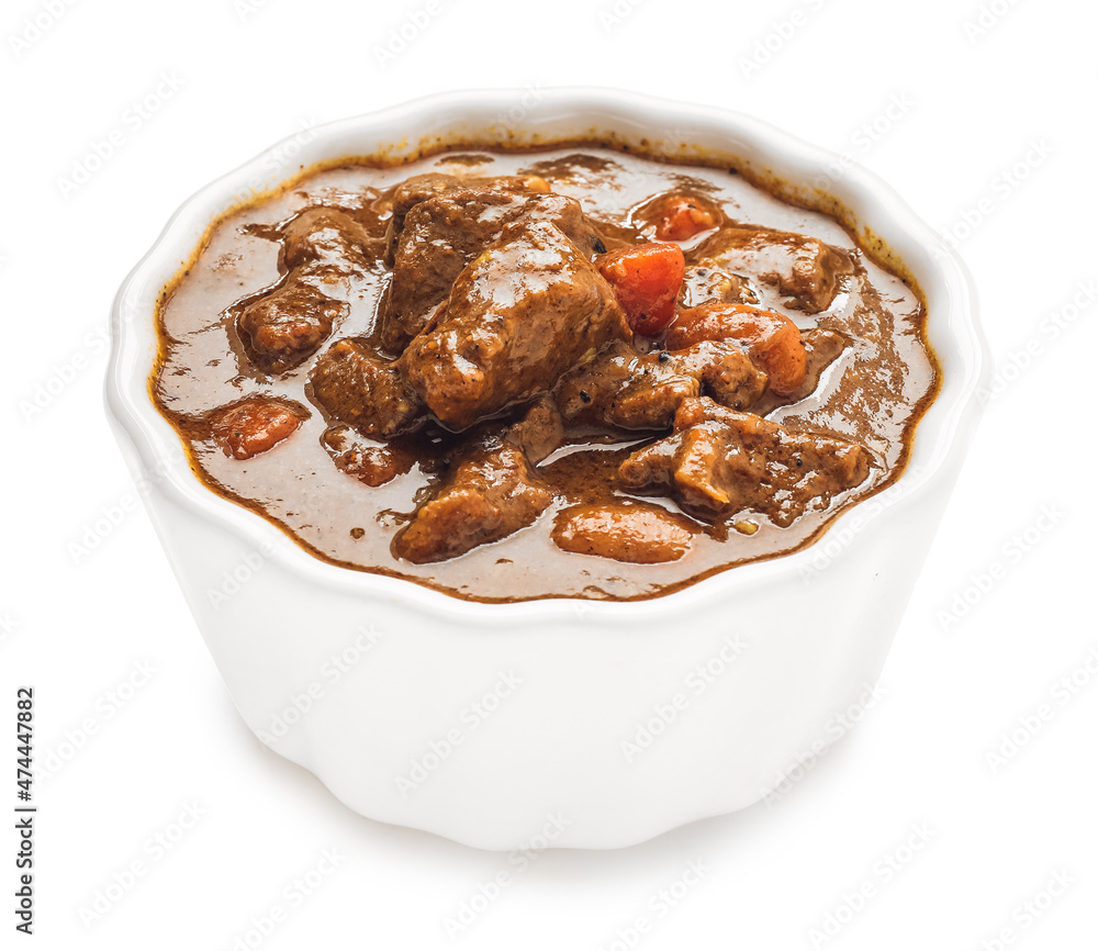 Bowl with tasty beef curry on white background