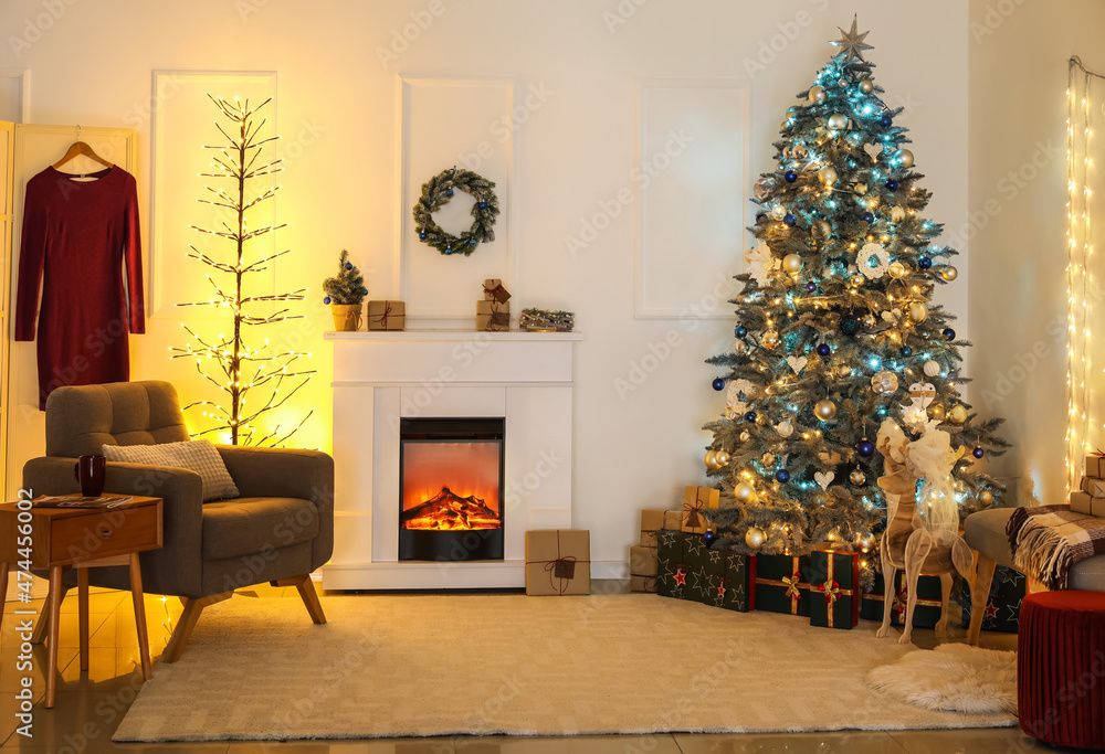 Stylish interior of living room with Christmas tree and fireplace