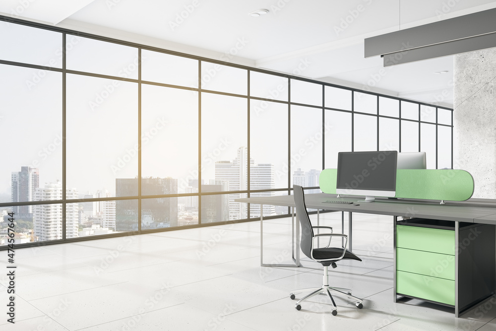 Contemporary concrete coworking office interior with empty mock up computer screen, window with city