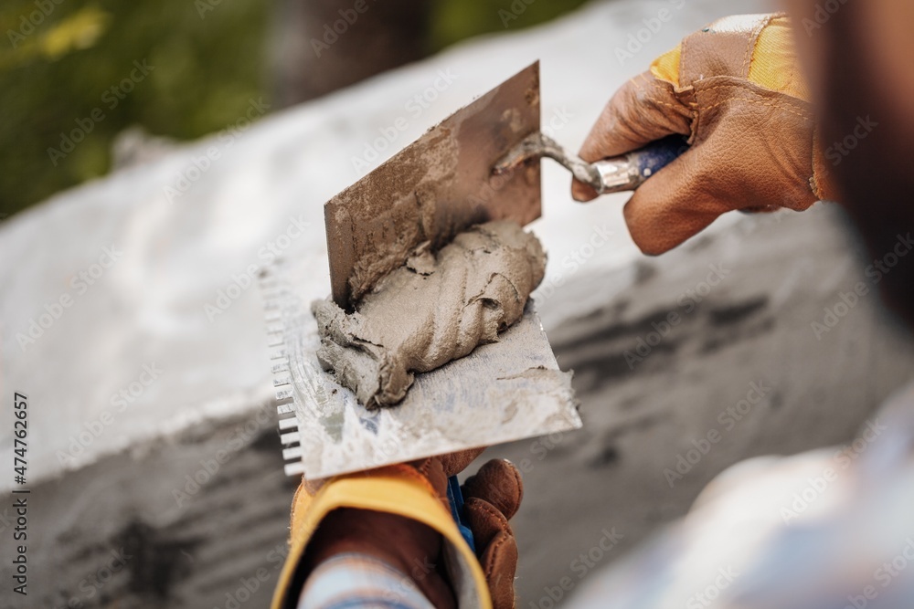 A worker with gloves lays down and dismantles the ceramic tiles of the stairs