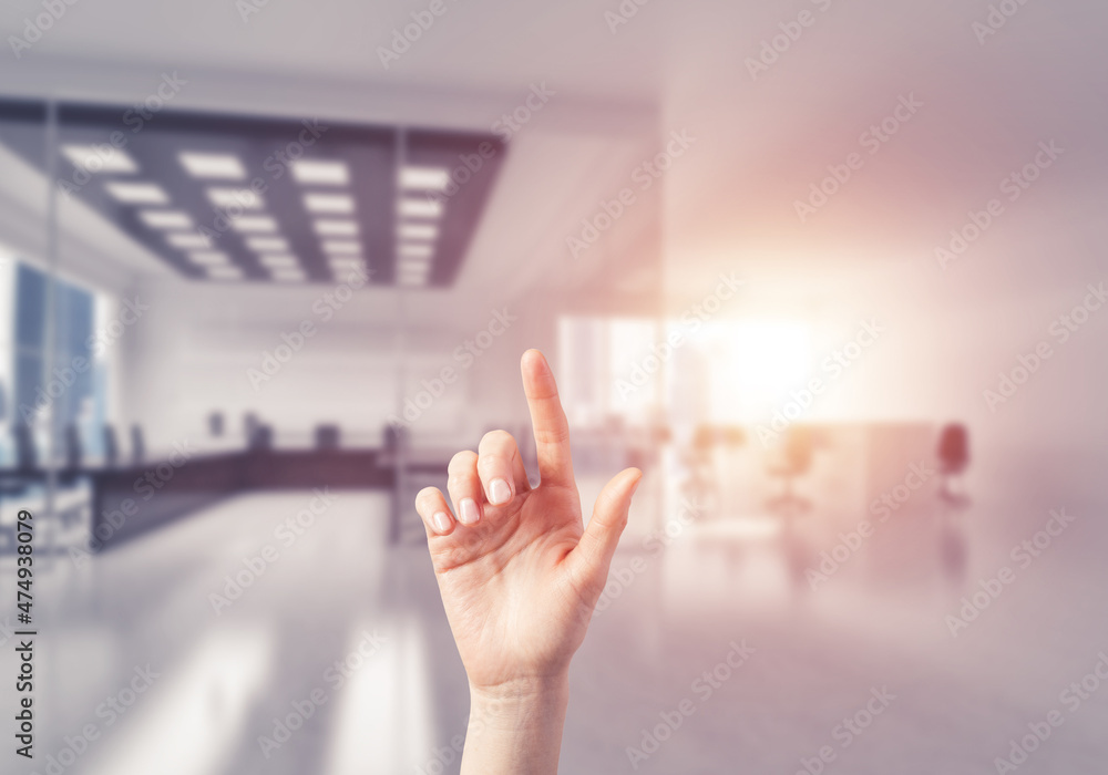 Choosing gesture of person in elegant modern interior in sunshine light