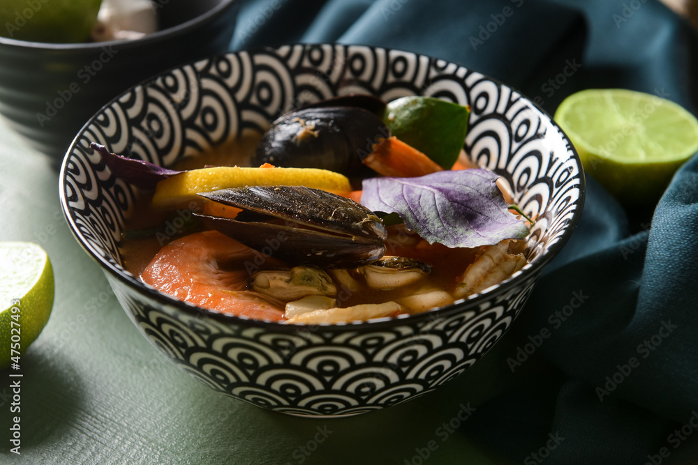 Bowl of spicy Thai soup on table