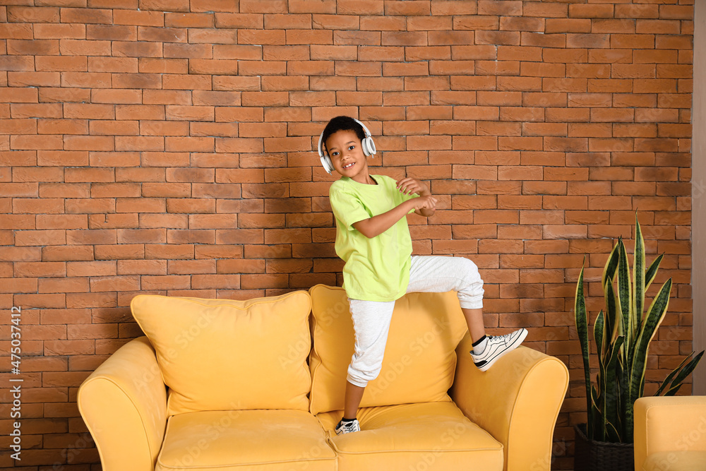 Dancing African-American boy listening to music at home