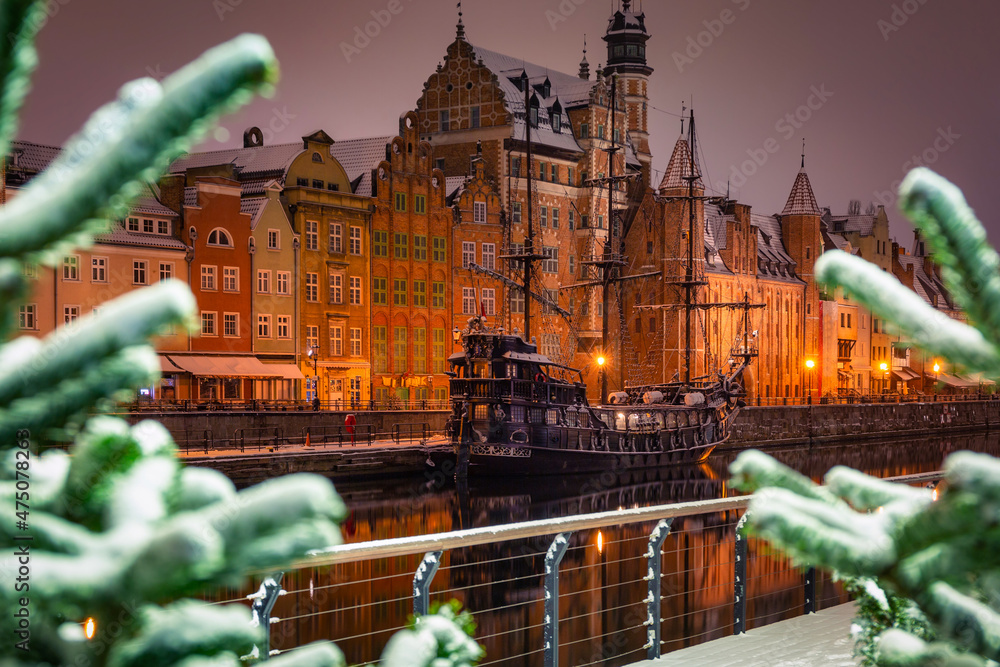 Beautiful architecture of the old town in Gdansk by the Motława river at wintery night. Poland