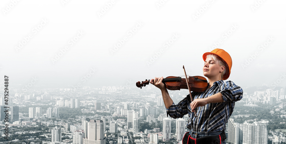 Beautiful woman in safety helmet playing violin