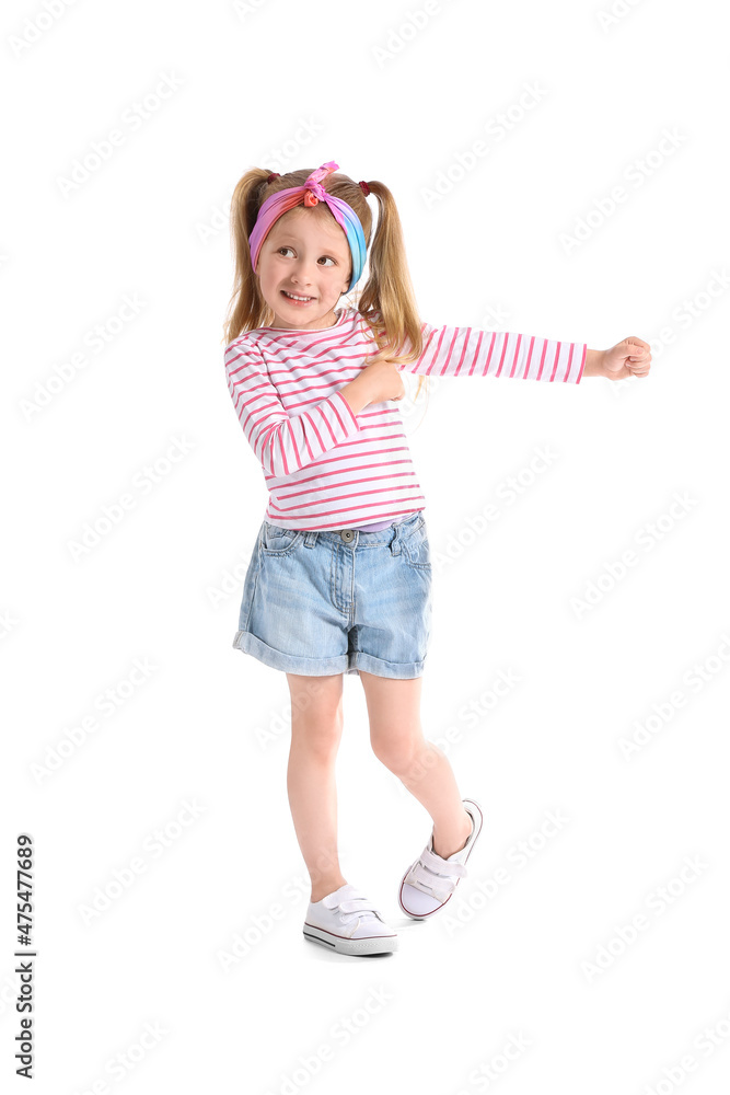 Cute little girl in striped longsleeve dancing on white background