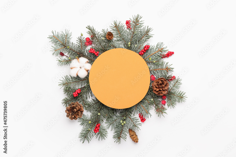 Composition with blank card, fir branches, cones and berries on white background