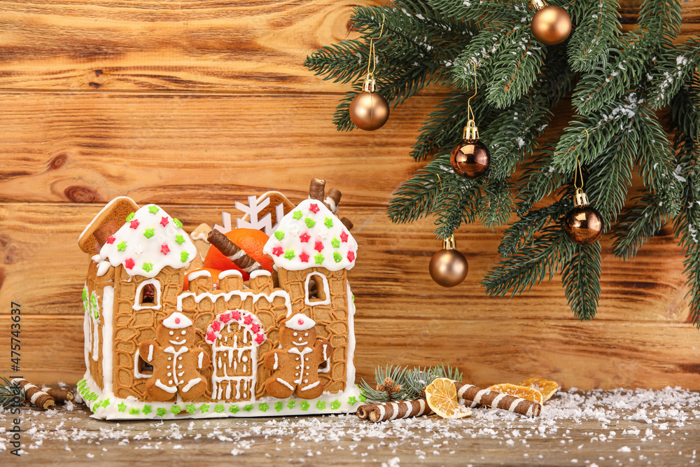 Beautiful gingerbread house and Christmas decor on wooden background