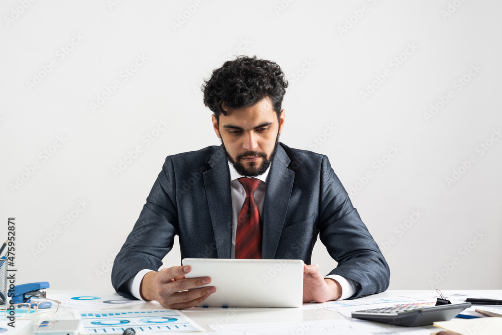 Arab businessman calculating budget at office desk