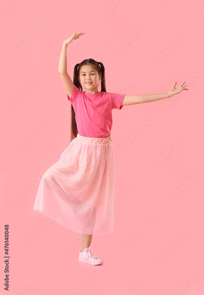 Dancing little girl on color background