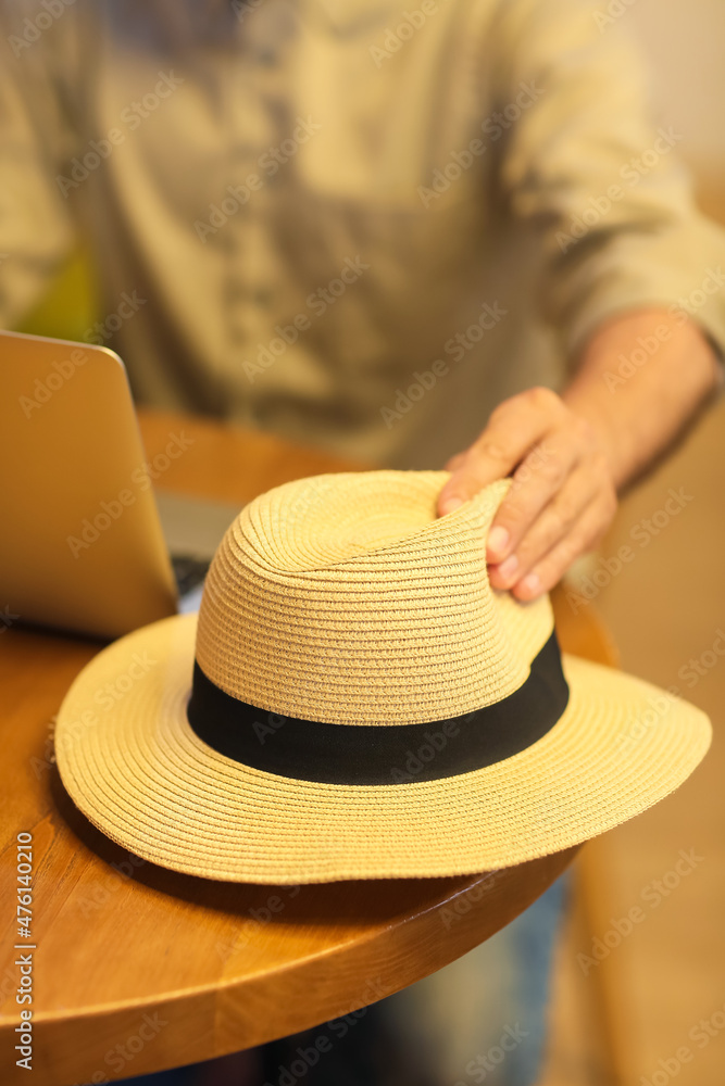 Mature man with hat at table in cafe