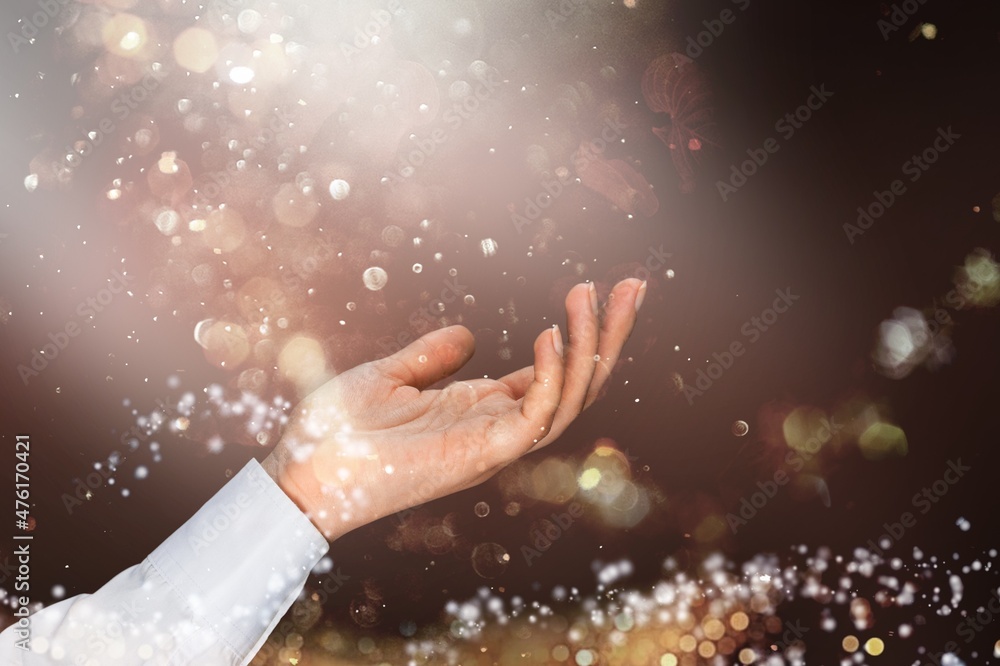 Stardust and magic in your hands. Magic particles on the palms of a hand