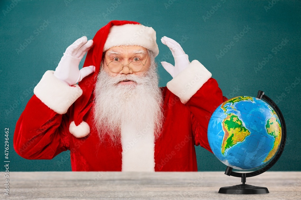 Portrait of cheerful amazed clever fat bearded Santa professional teacher with globe