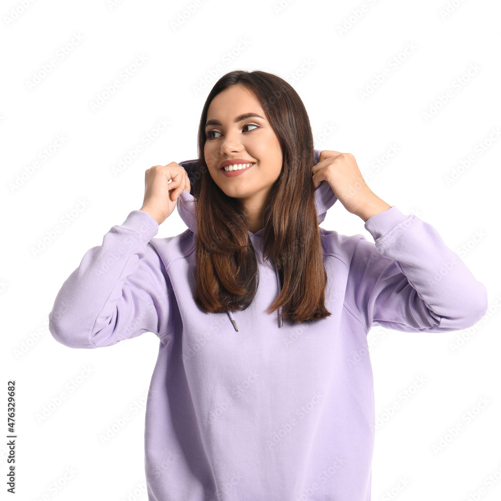 Beautiful young woman in stylish hoodie on white background