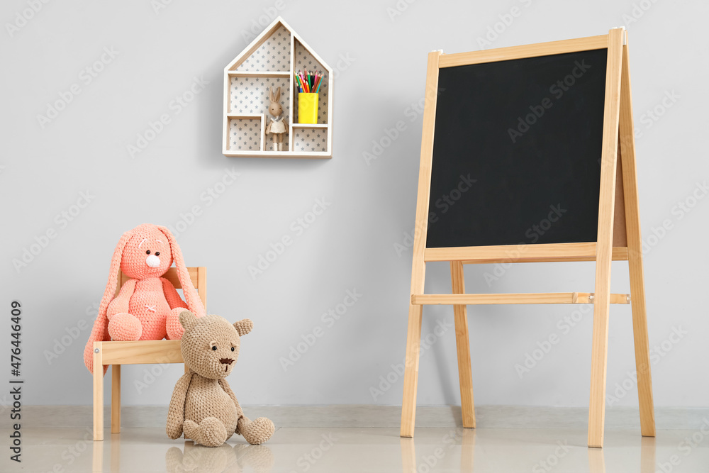 Chair with toys and chalkboard in interior of modern childrens room