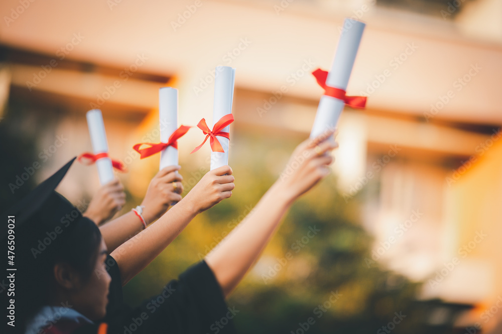 graduates wearing black hats holding university graduation certificates,Concept education congratula