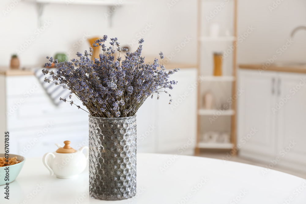 Vase with beautiful lavender flowers in kitchen