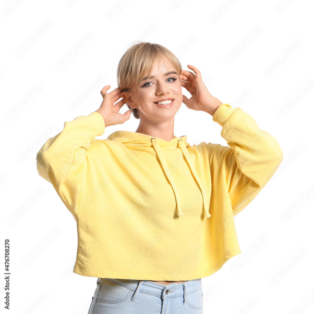 Beautiful young woman in stylish hoodie on white background