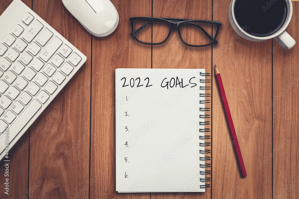 2022 Happy New Year Resolution Goal List and Plans Setting - Business office desk with notebook writ