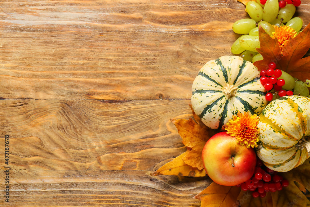 Different healthy food and autumn leaves on wooden background. Harvest festival