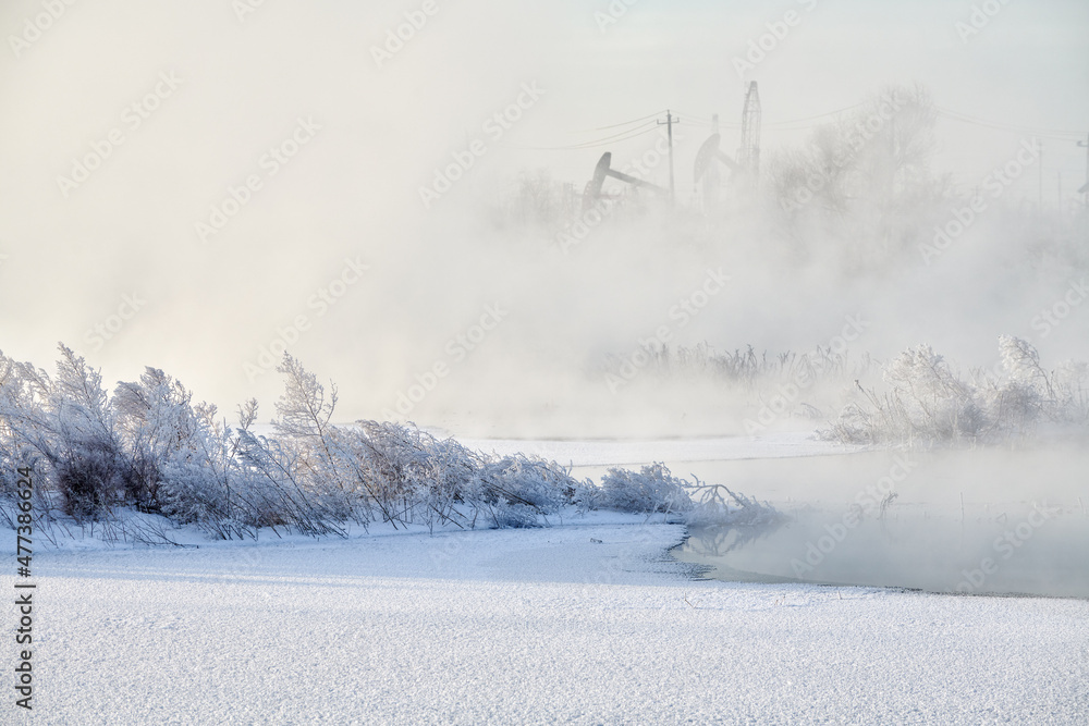 The pumping units in lakeside sunrise, Daqing oil fields Heilongjiang province, China.