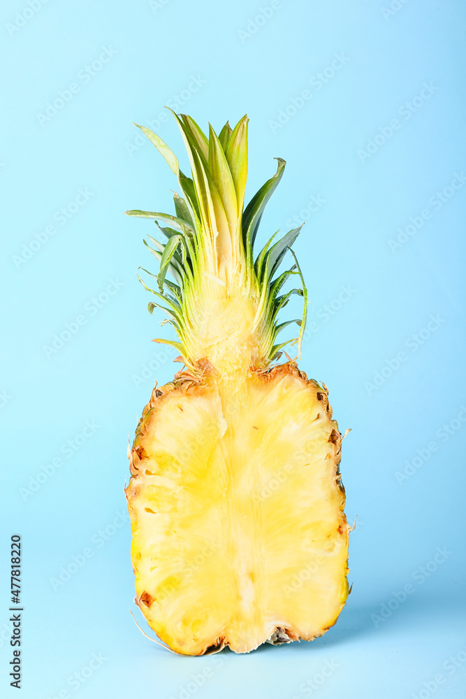 Half of ripe juicy pineapple on color background