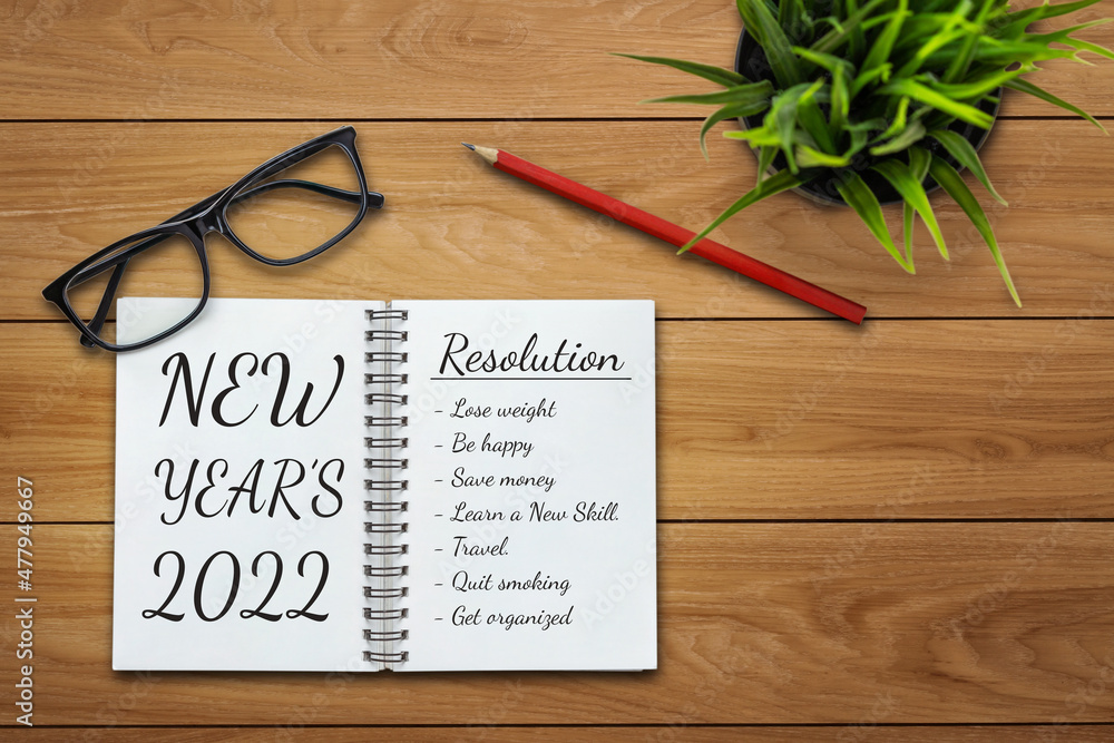 2022 Happy New Year Resolution Goal List and Plans Setting - Business office desk with notebook writ