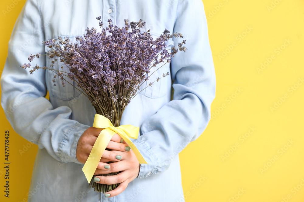 Woman with beautiful lavender flowers on color background